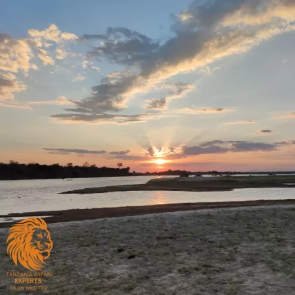 A scenic river at sunset during a boat safari in Nyerere (Selous) National Park, Tanzania.