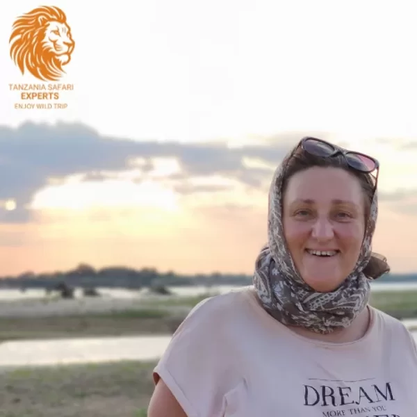 Tourist near Rufiji River on sunset in Nyerere (Selous) National Park, Tanzania.