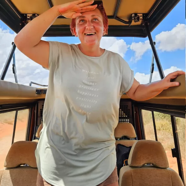 Woman watching wildlife from inside a safari jeep with a pop-up roof