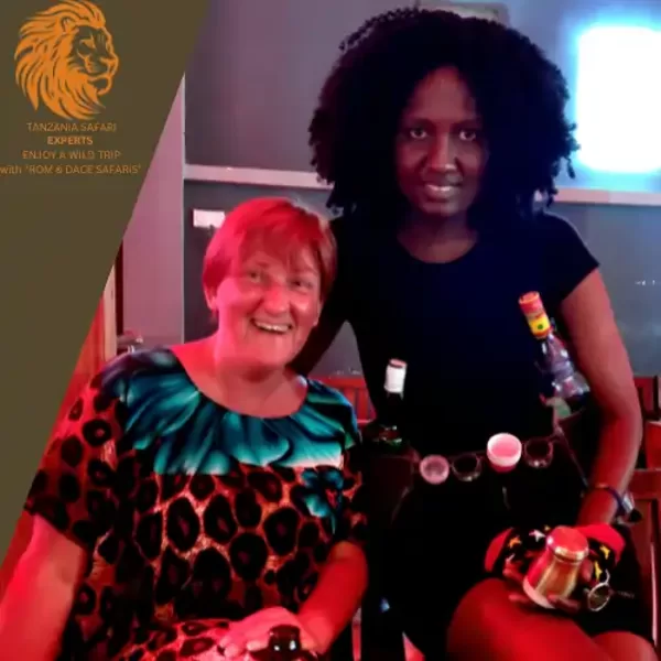Travelers with a local woman in Dar es Salaam during an evening experience
